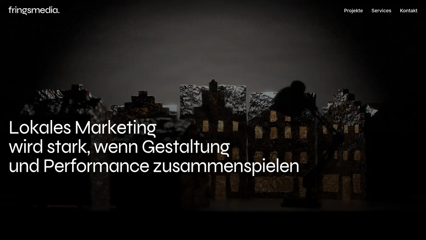 Startseite von fringsmedia: dunkles Hero-Bild einer Modellstadt mit großer Überschrift